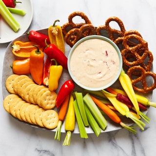 Photo of Hot Pimento Cheese Dip served with vegetables crackers and pretzels.