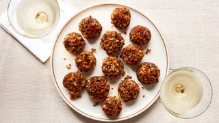 A plate of roasted mushrooms stuffed with seasoned bread crumbs.