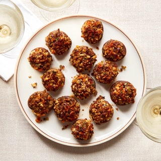 A plate of roasted mushrooms stuffed with seasoned bread crumbs.